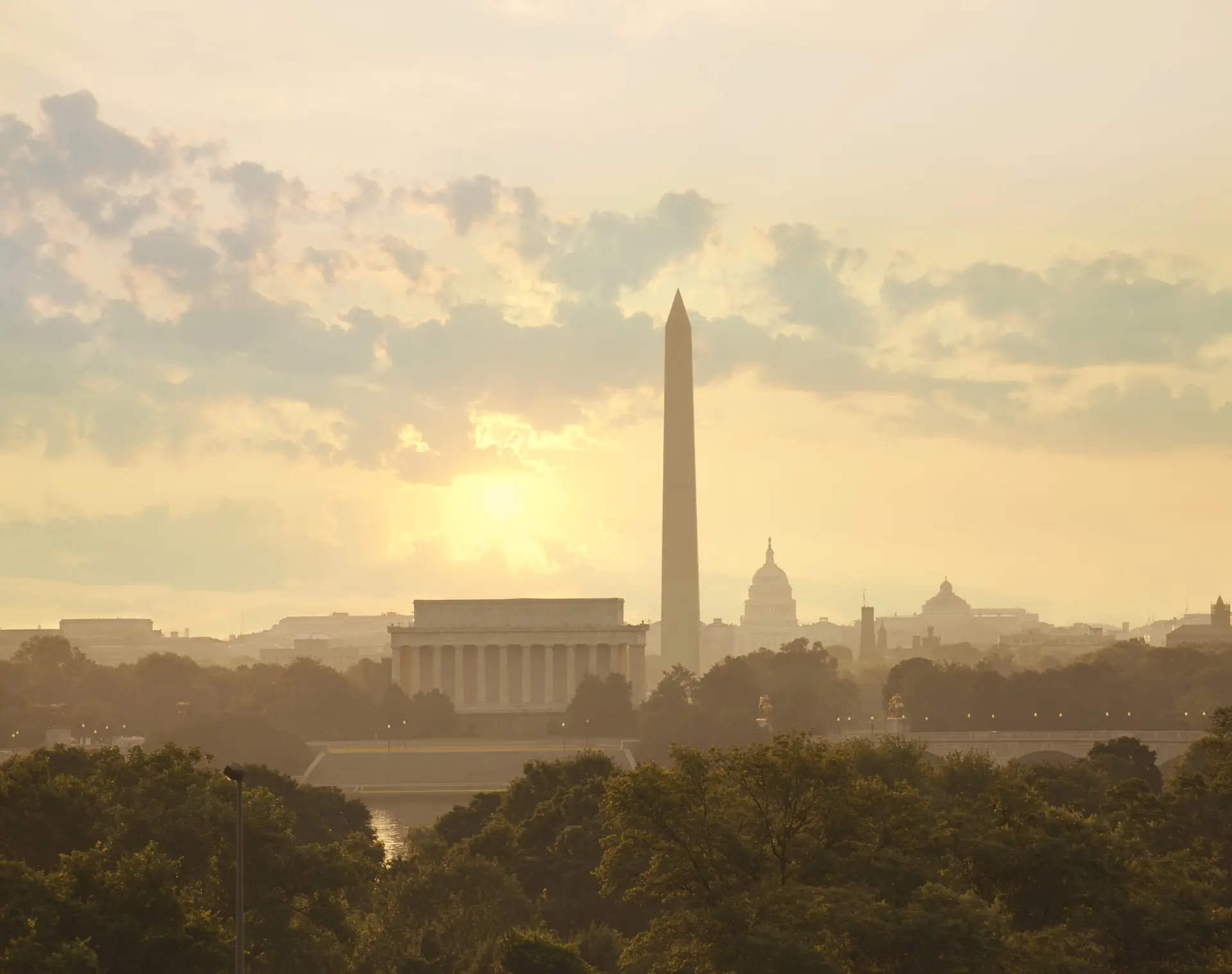 Washington DC skyline with sun and clouds in the morning