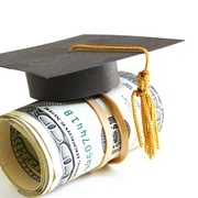 mini graduation cap on a roll of money